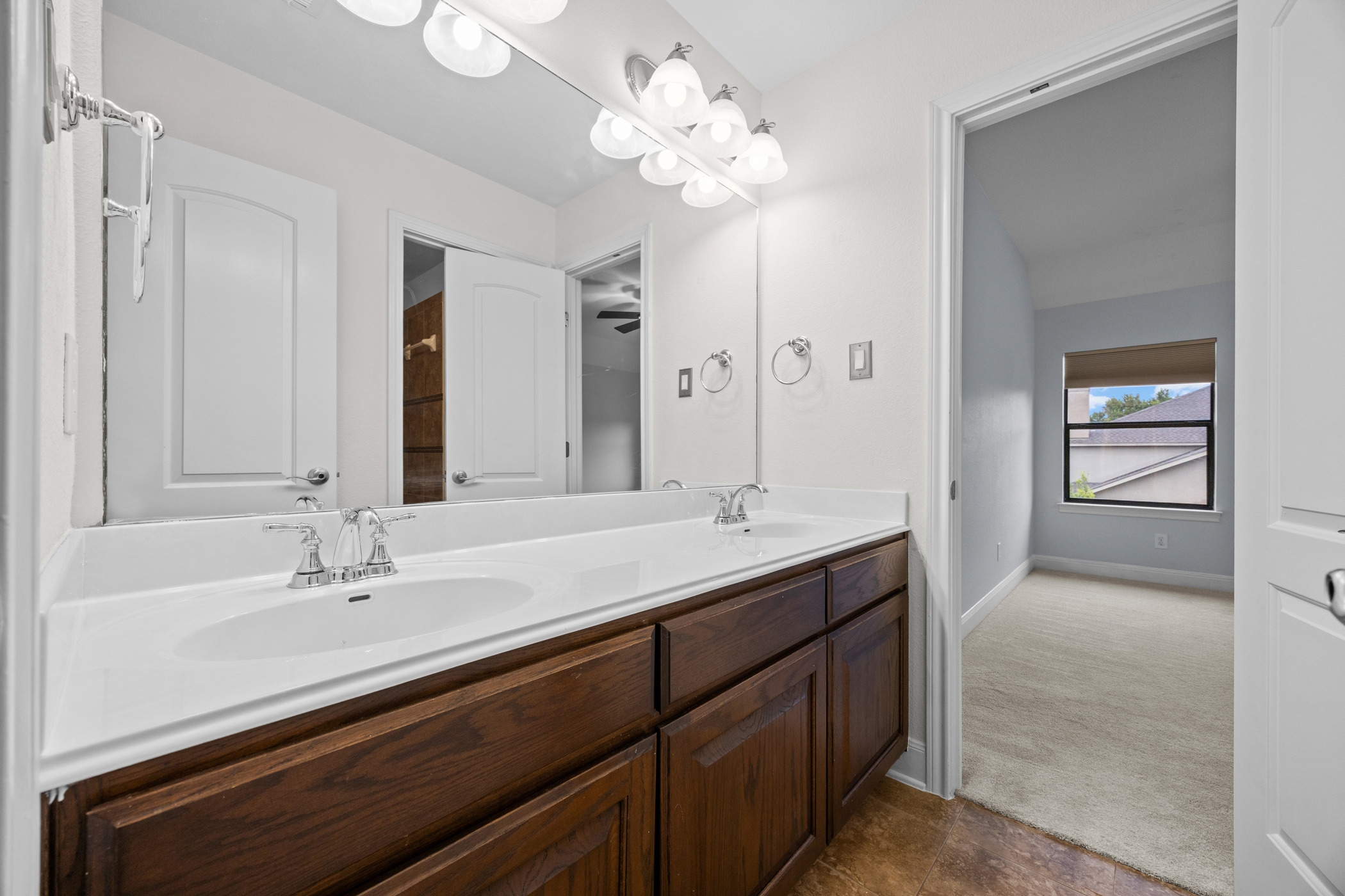 2300 Lakehurst Road Spicewood, TX 78669 - Photo 26 of 40 Bathroom featuring double vanity and dark colored carpet