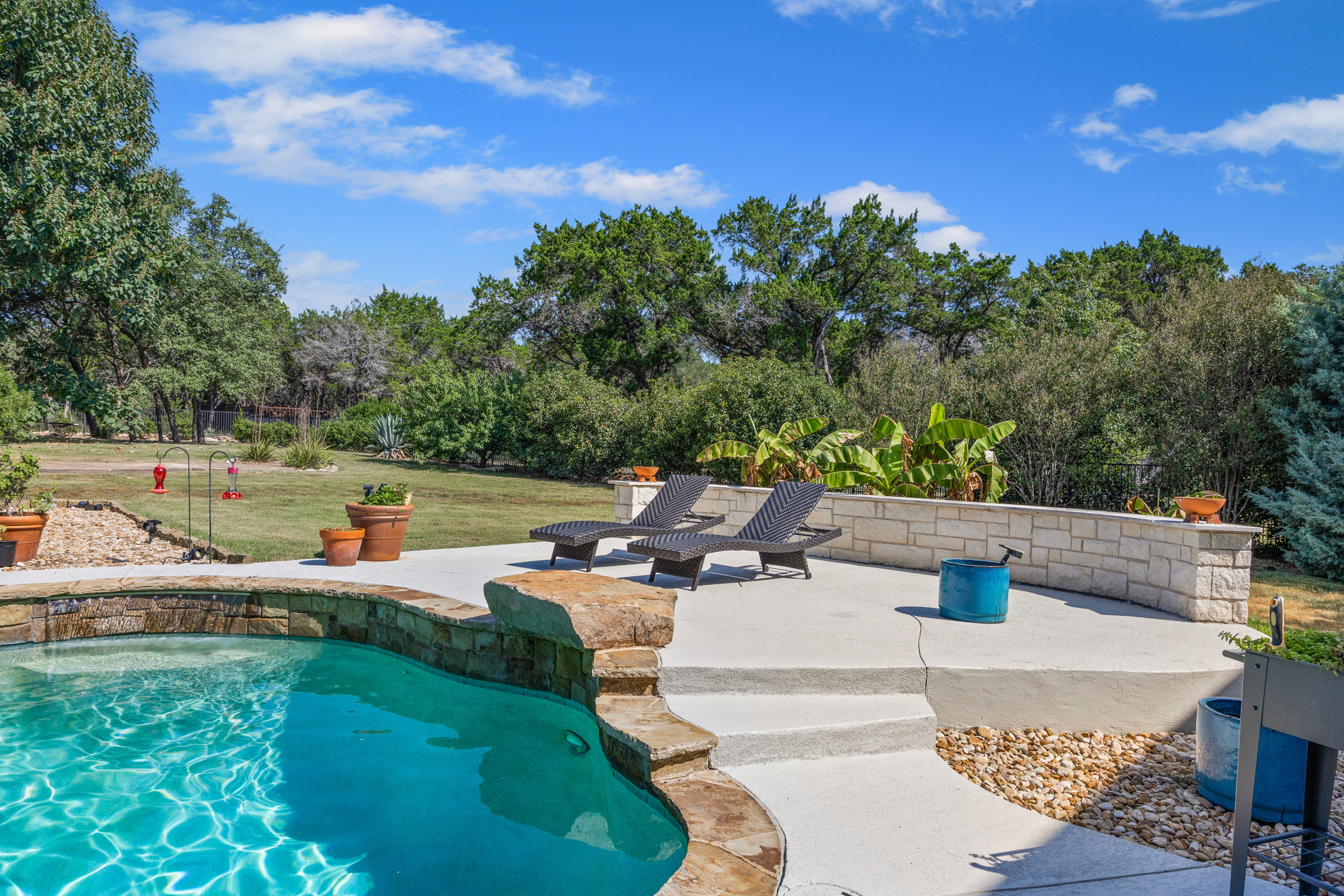 2300 Lakehurst Road Spicewood, TX 78669 - Photo 33 of 40 Swimming pool featuring a patio area, a yard, and view of scattered trees