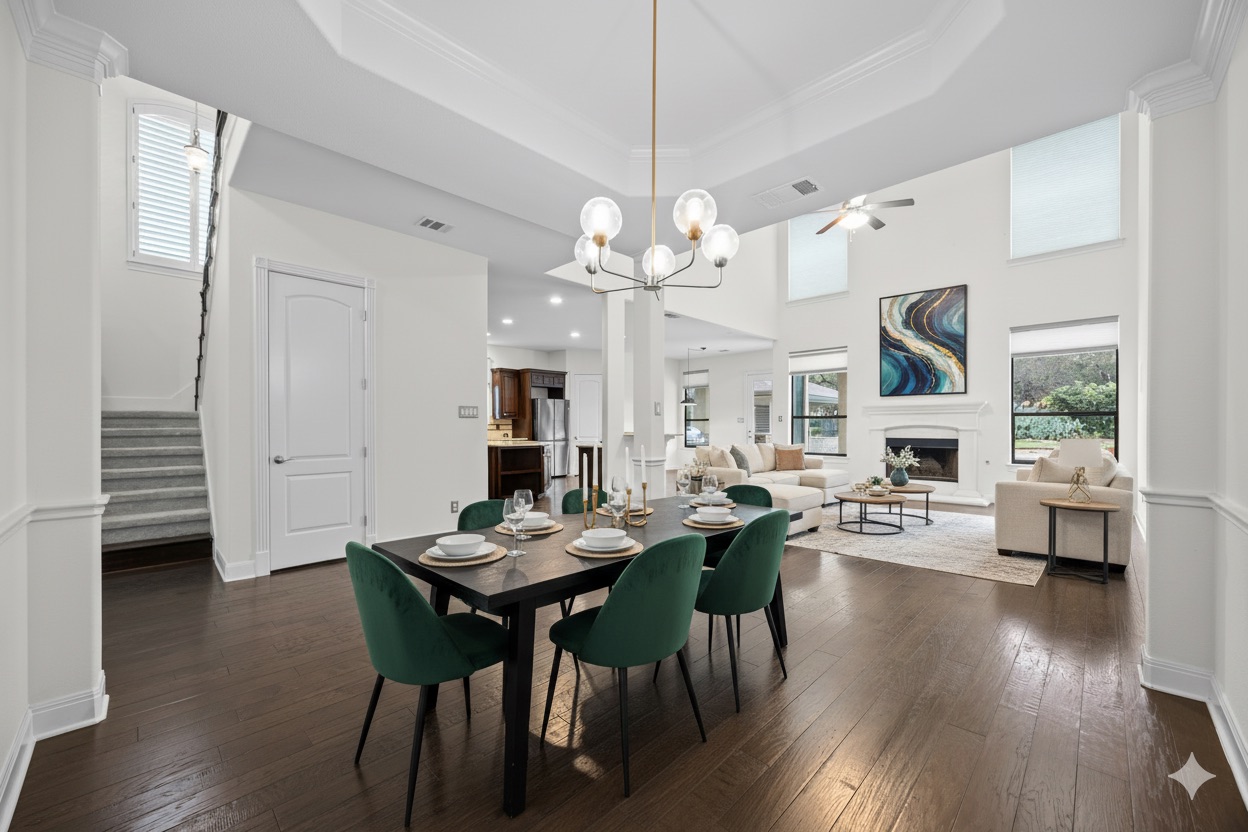 2300 Lakehurst Road Spicewood, TX 78669 - Photo 9 of 40 Dining area featuring dark wood finished floors, hanging lights, ceiling fan, a fireplace, and ornamental molding- virtually staged