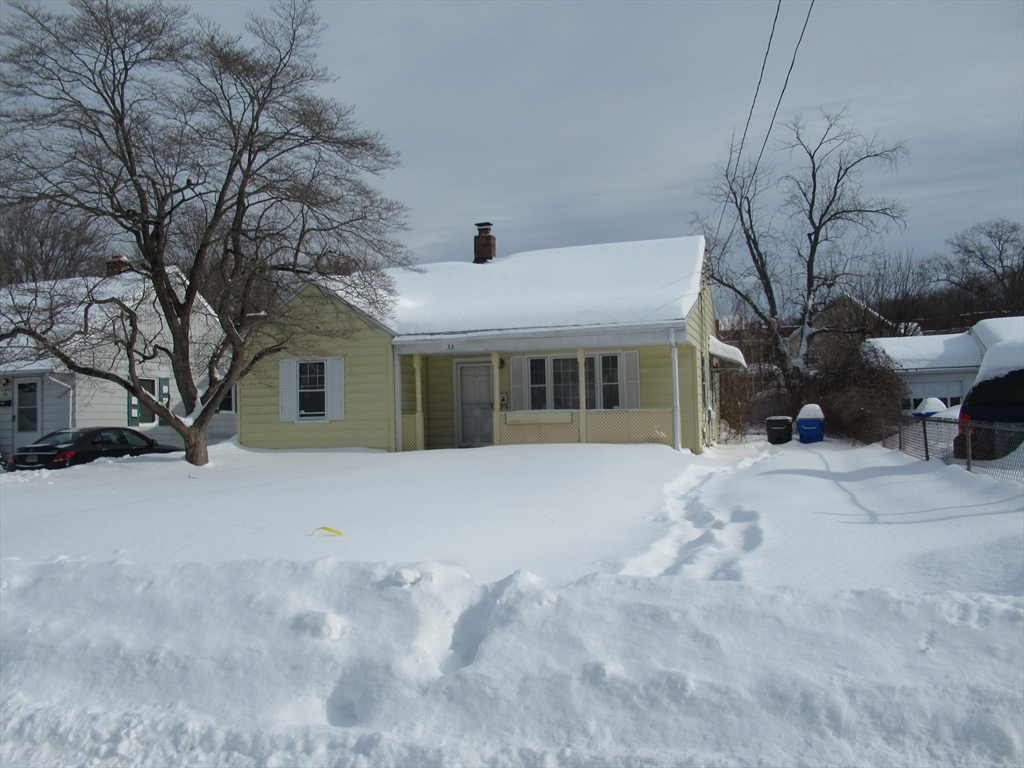 33 Connolly Street Springfield, MA 01151 - Photo 3 of 6 a front view of a house with a yard covered in snow