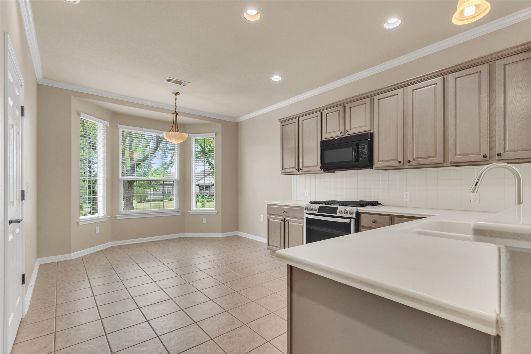 409 Rio Grande Loop Georgetown, TX 78633 - Photo 11 of 34 Kitchen with decorative light fixtures, stainless steel gas range, light countertops