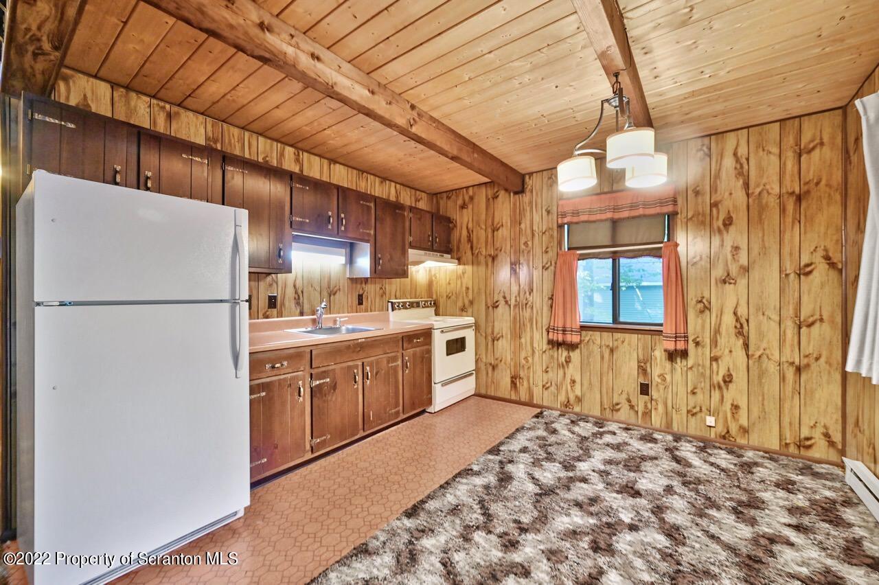 1038 Beaver Run Road Newfoundland, PA 18445 - Photo 8 of 34 a kitchen with stainless steel appliances granite countertop a refrigerator a oven and white cabinets