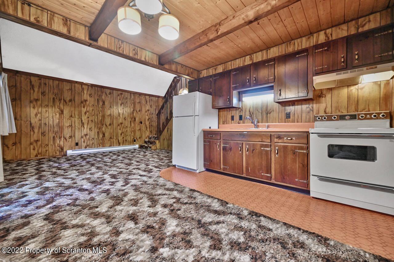 1038 Beaver Run Road Newfoundland, PA 18445 - Photo 9 of 34 a kitchen with a stove and a refrigerator