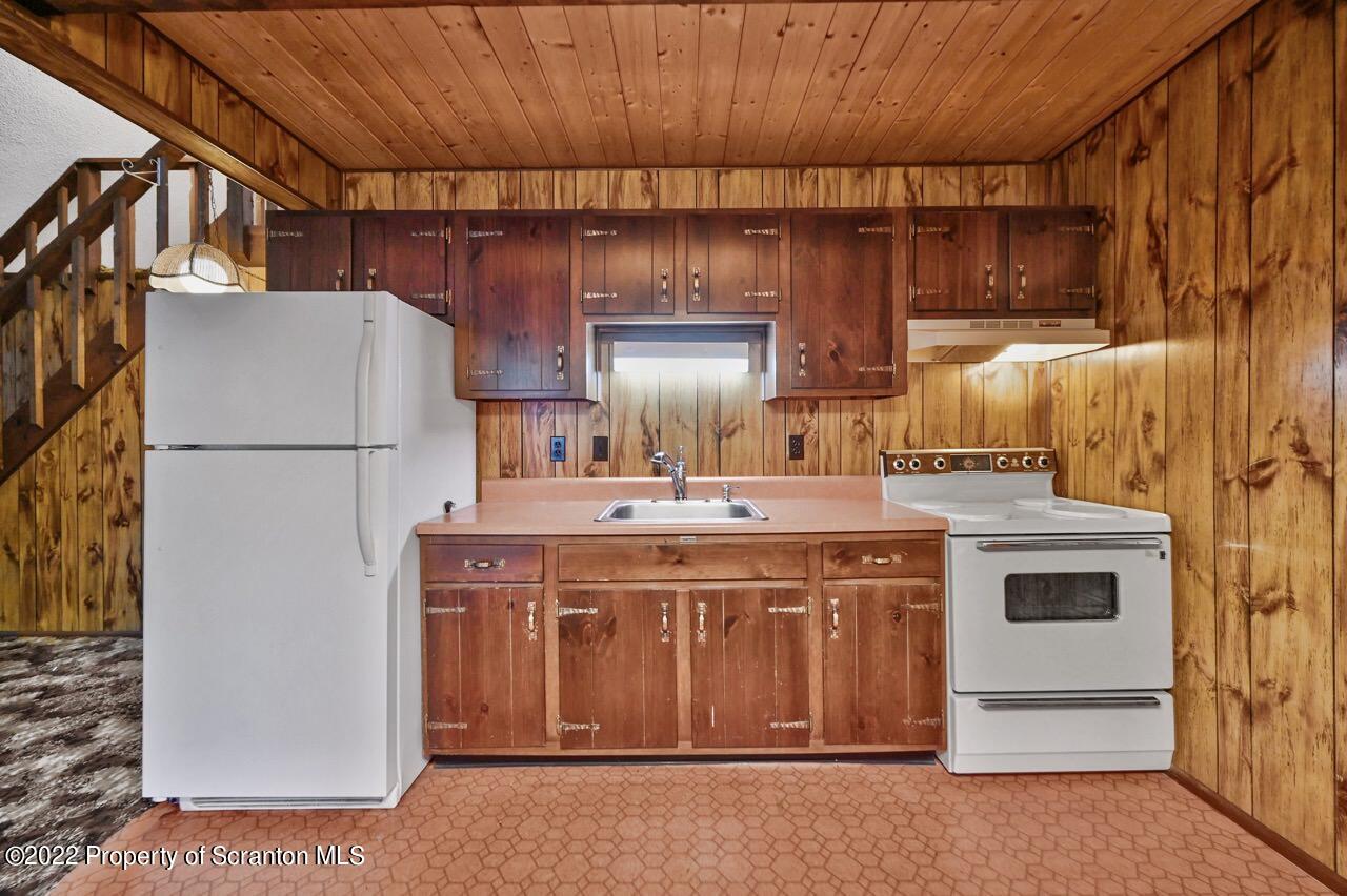 1038 Beaver Run Road Newfoundland, PA 18445 - Photo 10 of 34 a kitchen with a stove and a refrigerator