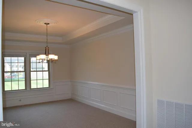 a view of a room that has a window and furniture