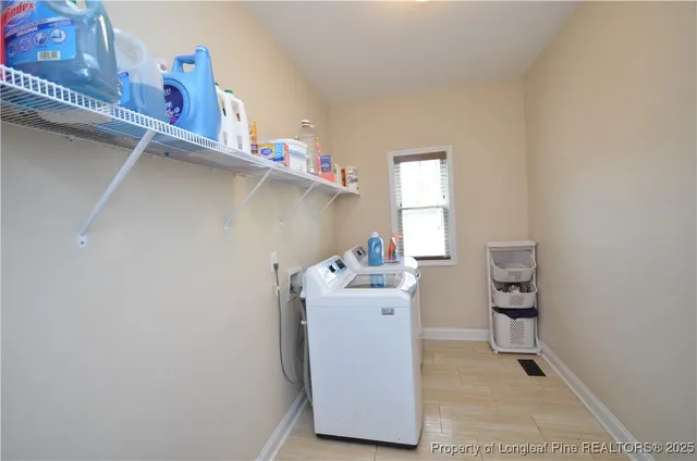 a utility room with a sink washer and dryer