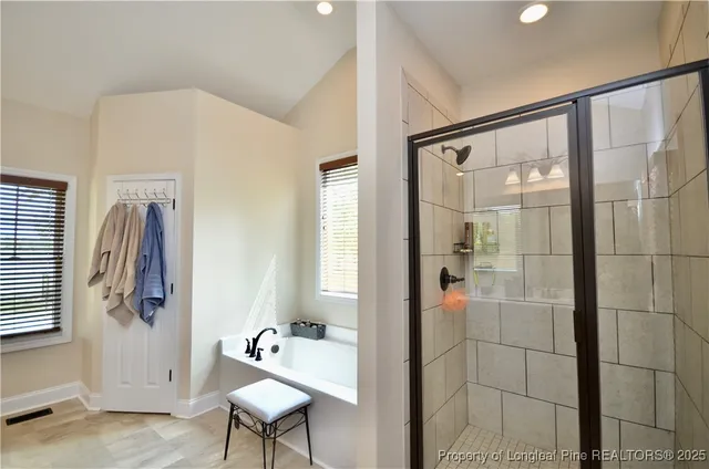 a bathroom with a bathtub and a shower