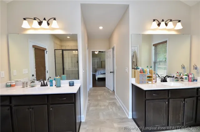 a bathroom with a sink double vanity and a mirror