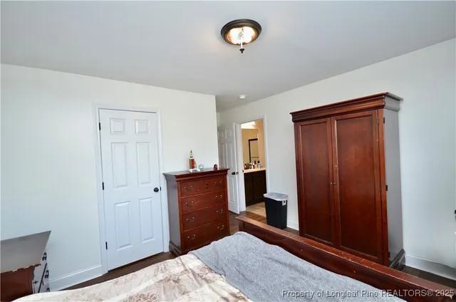 a bedroom with a bed and a mirror