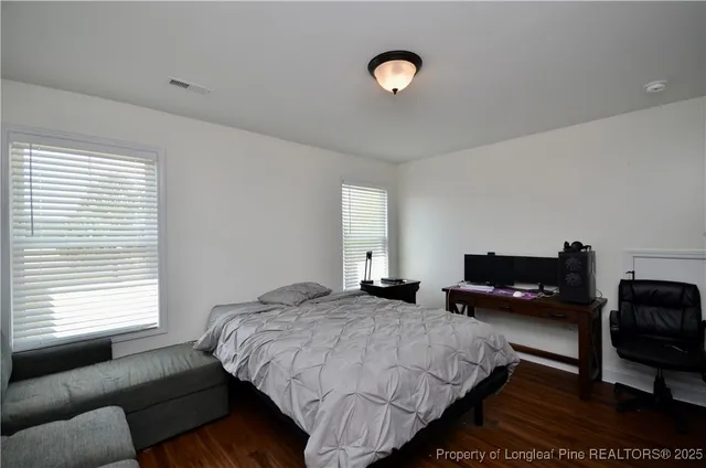 a bedroom with a bed and a couch