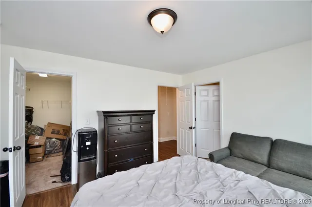 a bedroom with a bed and a television