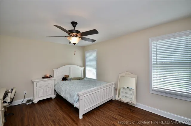 a bedroom with a bed and a ceiling fan
