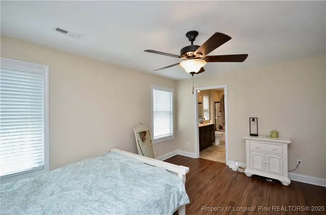 a bedroom with furniture and a ceiling fan