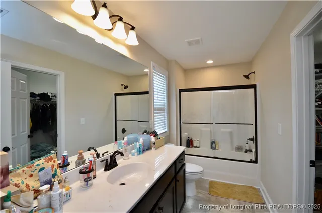 a bathroom with a sink mirror and vanity