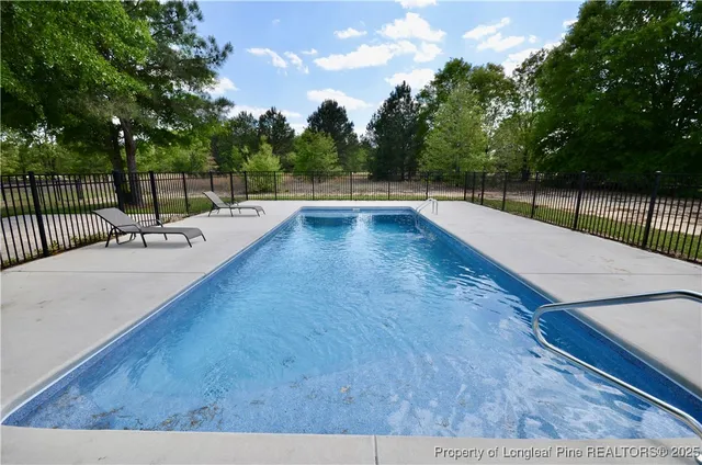 a view of a swimming pool with a patio