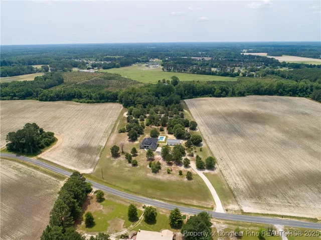 an aerial view of a residential houses with city view