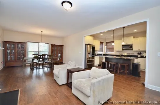 a living room with furniture and kitchen view
