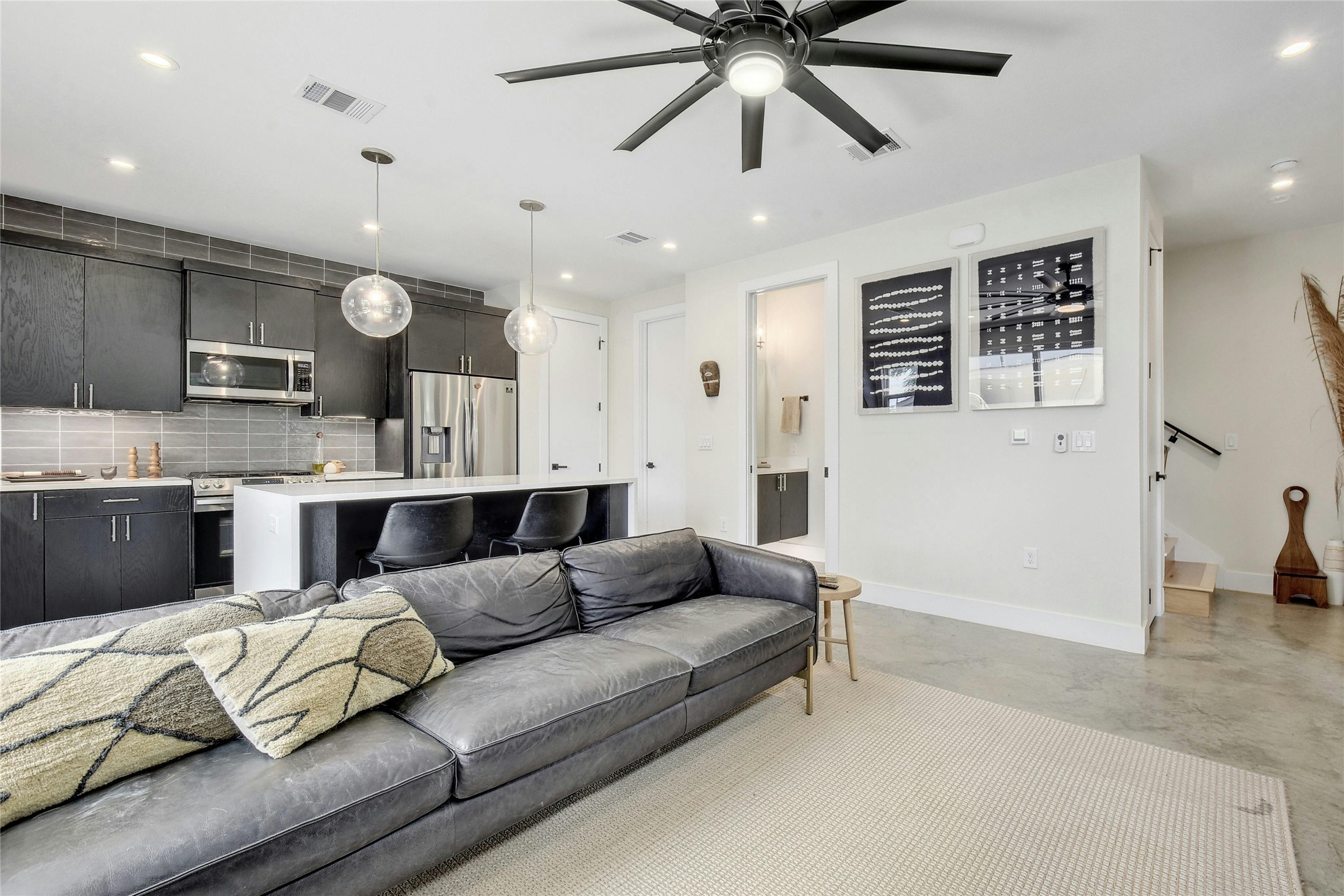 4606 Ledesma Road, Unit 2 Austin, TX 78721 - Photo 7 of 33 An open concept living area seamlessly blends a modern kitchen with a comfortable lounge space.