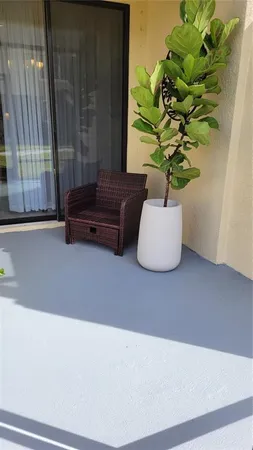 a white vase with white and yellow flowers