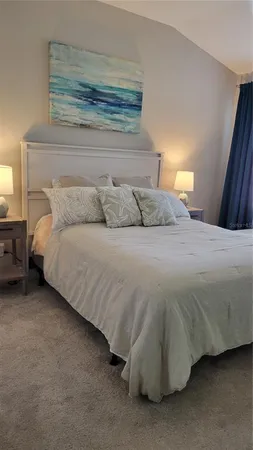 a bedroom with a bed and a lamp