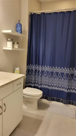 a bathroom with a toilet a sink and a shower