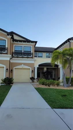 a front view of a house with a garden and a yard
