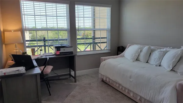 a bed room with a bed and a chair