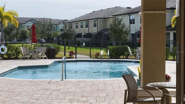 a view of a chairs and table in backyard