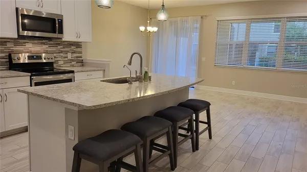 a kitchen with a sink cabinets and appliances