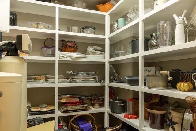 a shelf with cup and plates