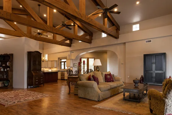a living room with furniture and a chandelier