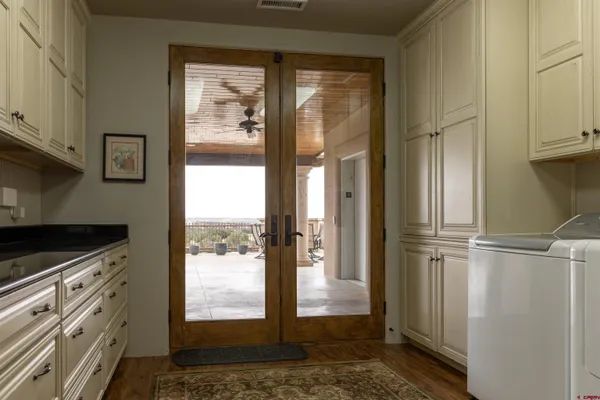 a view of kitchen with stainless steel appliances granite countertop cabinets and a window