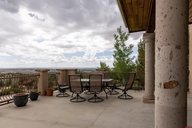 a view of balcony with couple of cars parked