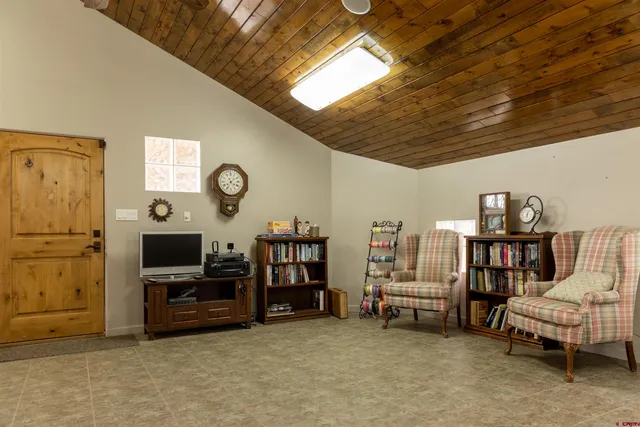 a view of a livingroom with furniture and a flat screen tv