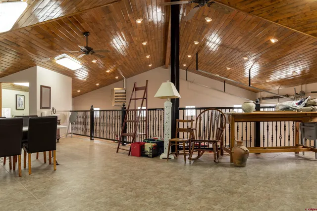 a view of a porch with chairs and a grill
