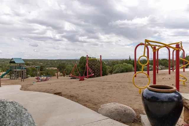 a view of a yard with table and chairs and potted plants