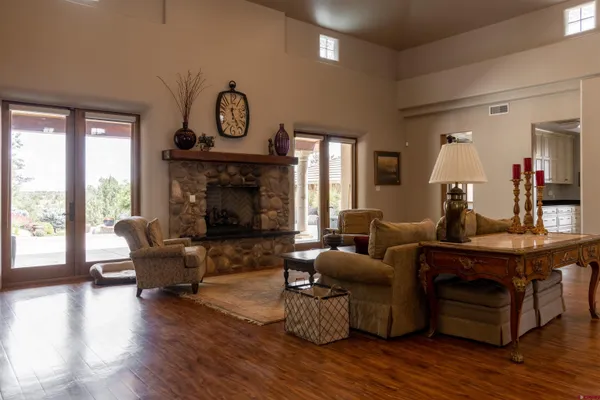 a living room with furniture wooden floor and a fireplace