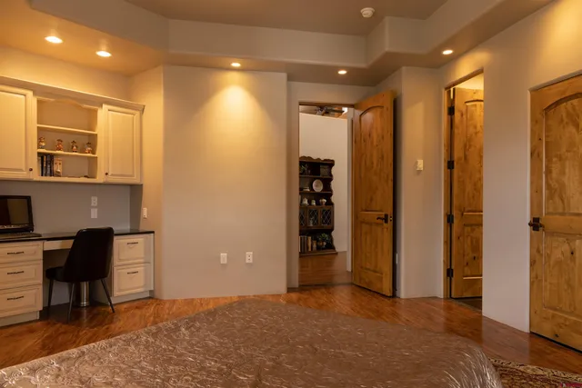a view of a hallway with living room and wooden floor
