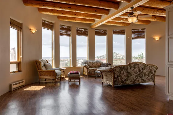 a living room with furniture and floor to ceiling windows