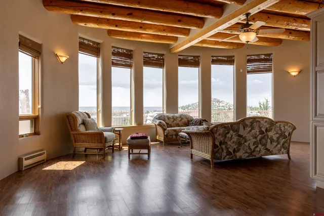 a living room with furniture and floor to ceiling windows