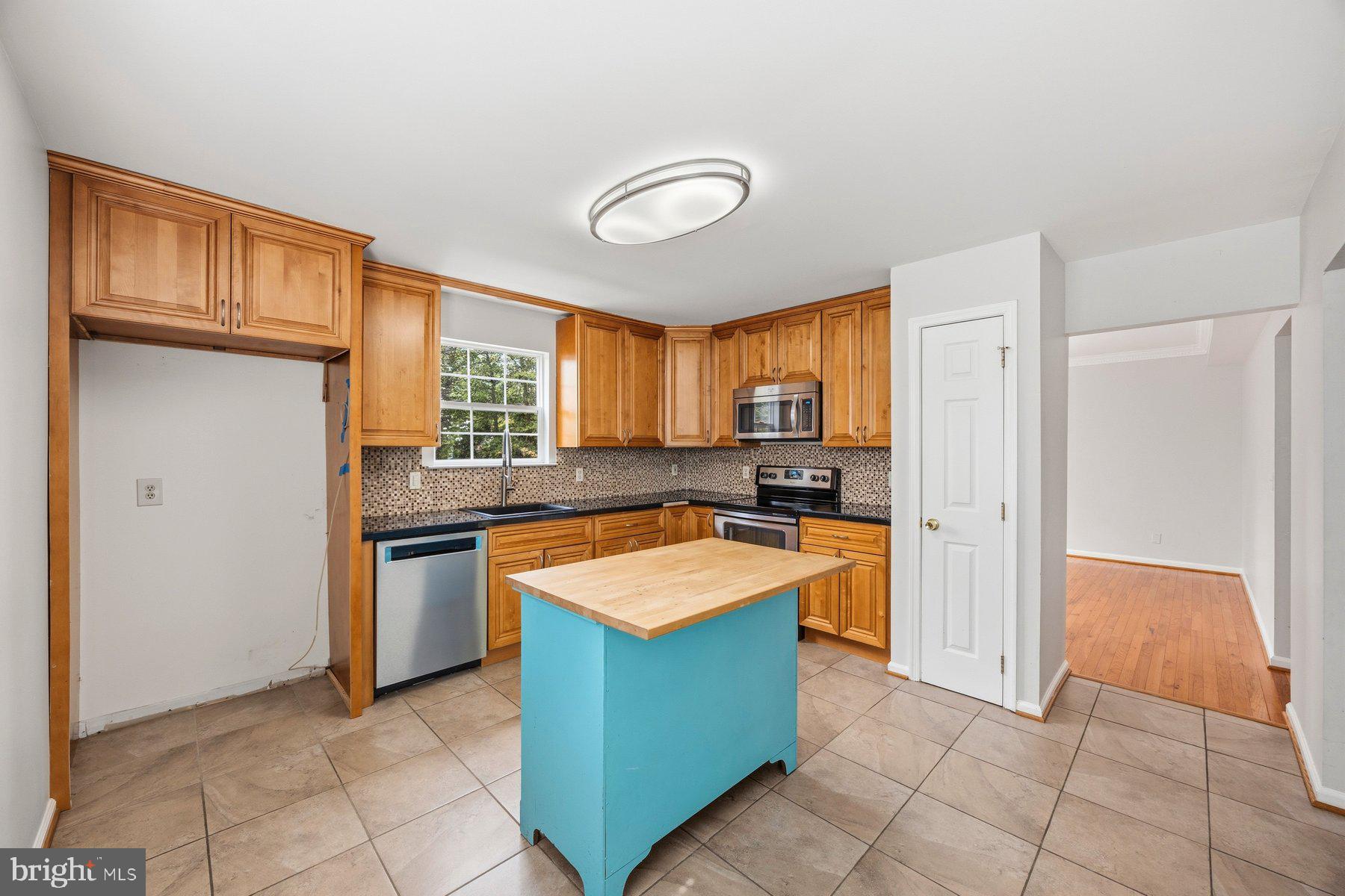 50 Robinson Landing Road Severna Park, MD 21146 - Photo 11 of 38 a kitchen with granite countertop a sink counter top space and stainless steel appliances