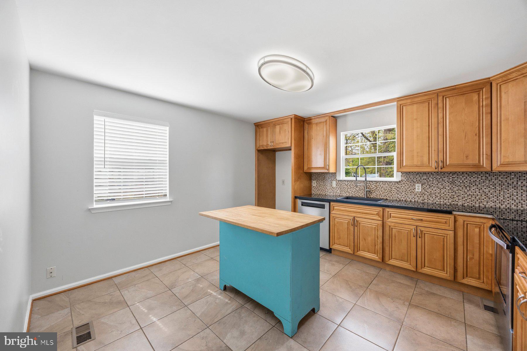 50 Robinson Landing Road Severna Park, MD 21146 - Photo 12 of 38 a kitchen with granite countertop sink and cabinets
