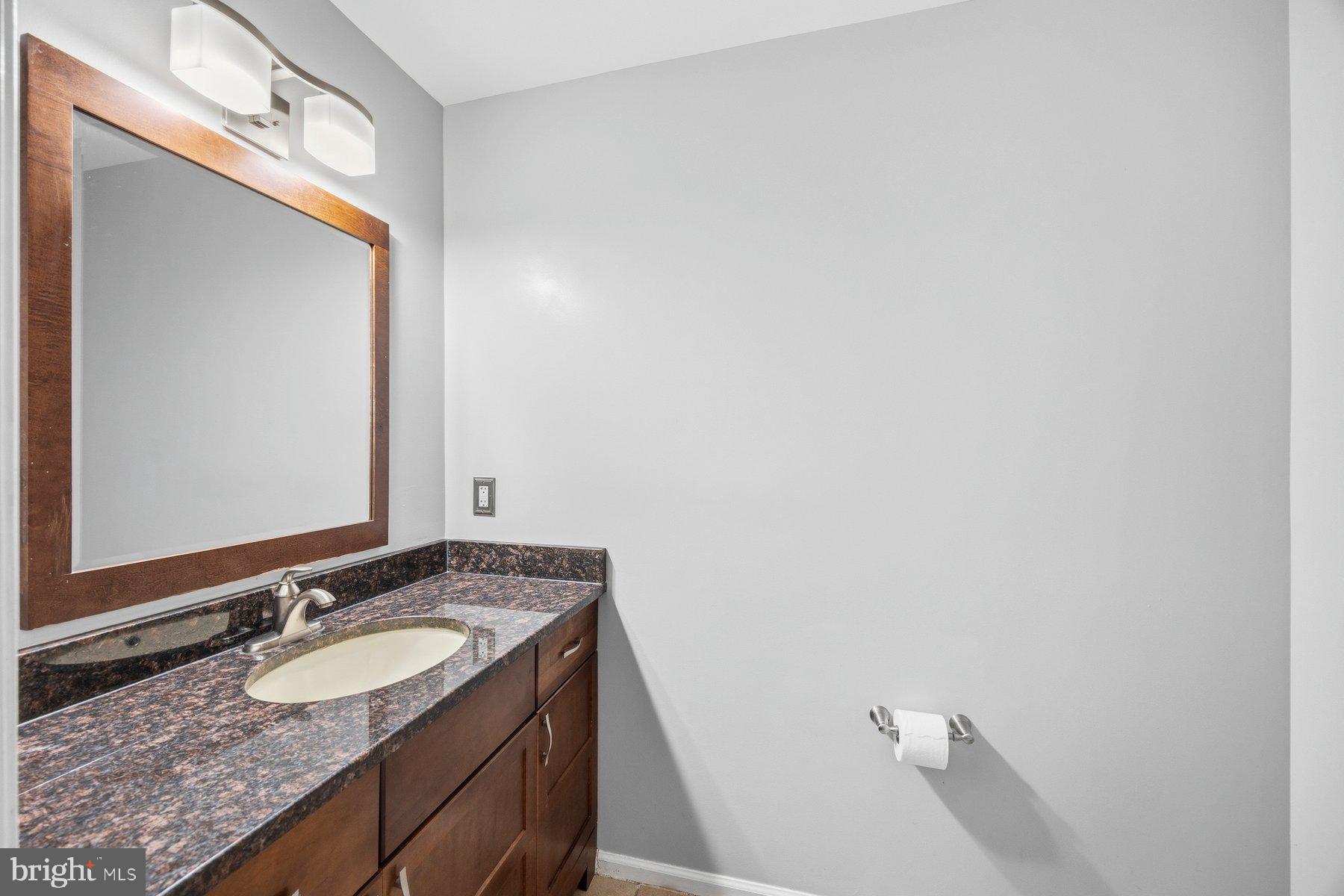 50 Robinson Landing Road Severna Park, MD 21146 - Photo 18 of 38 a bathroom with a granite countertop sink and a mirror