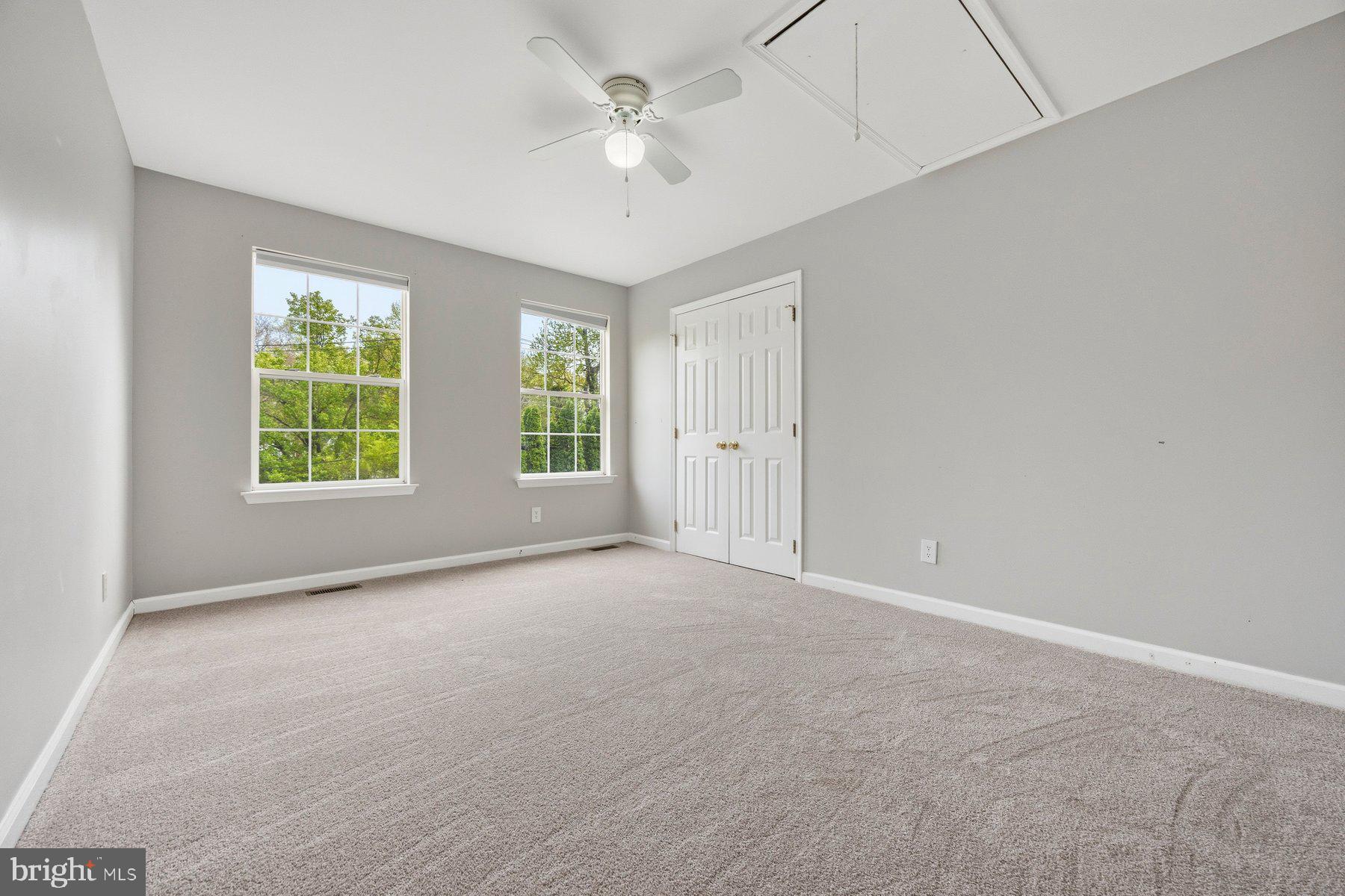 50 Robinson Landing Road Severna Park, MD 21146 - Photo 19 of 38 an empty room with windows and ceiling fan