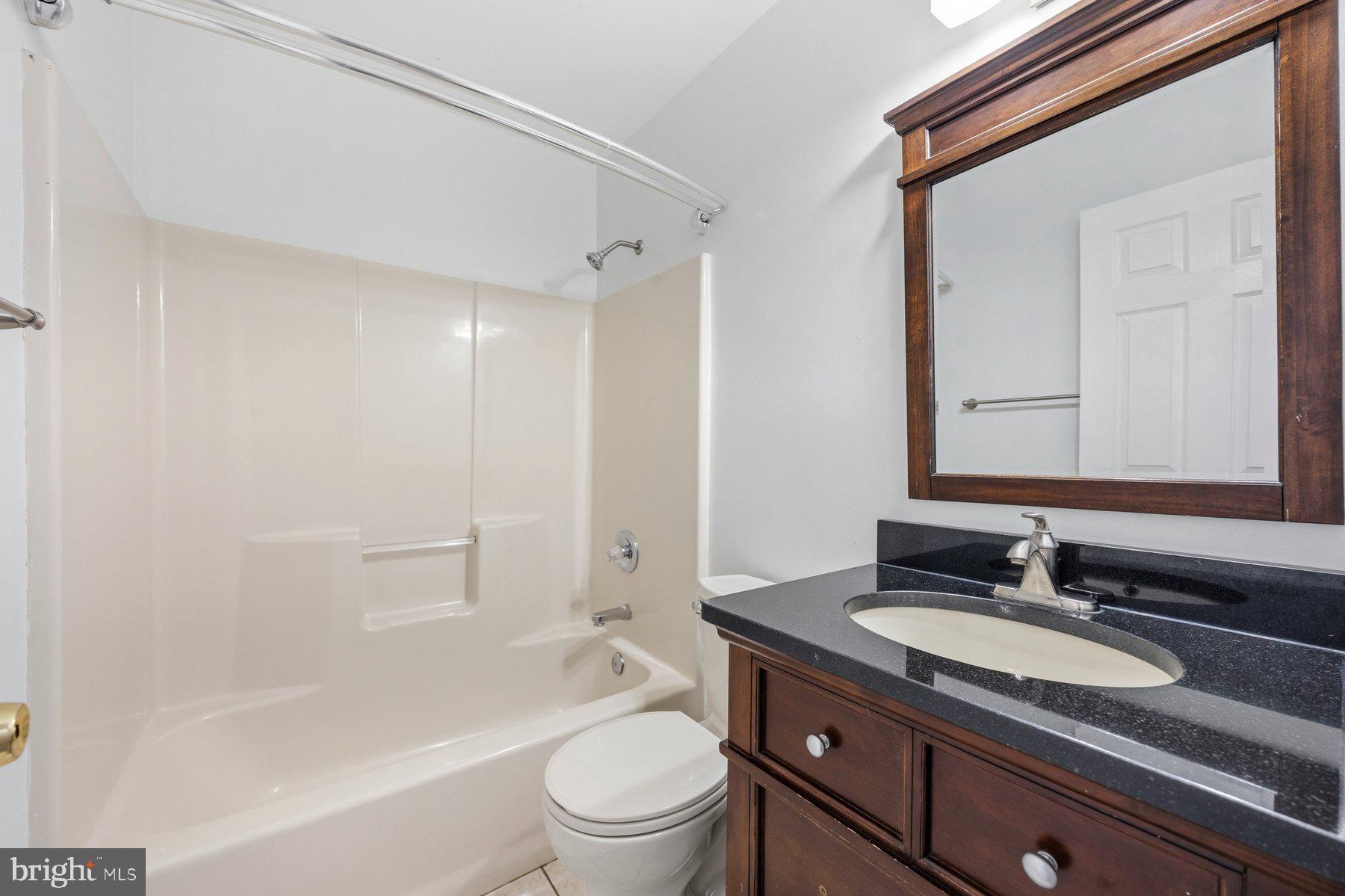 50 Robinson Landing Road Severna Park, MD 21146 - Photo 21 of 38 a bathroom with a granite countertop sink a toilet and shower