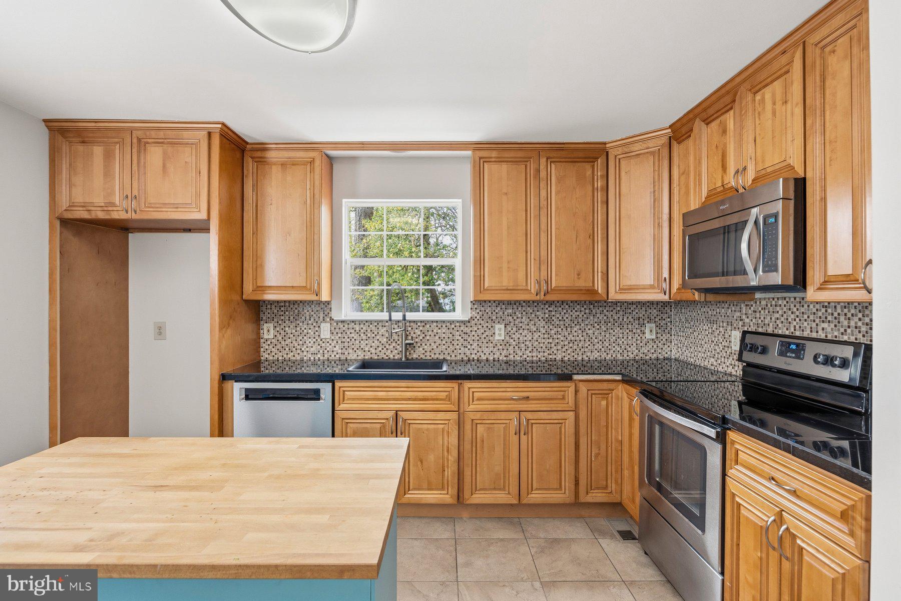 50 Robinson Landing Road Severna Park, MD 21146 - Photo 6 of 38 a kitchen with stainless steel appliances granite countertop a stove a sink dishwasher and a microwave oven with cabinets