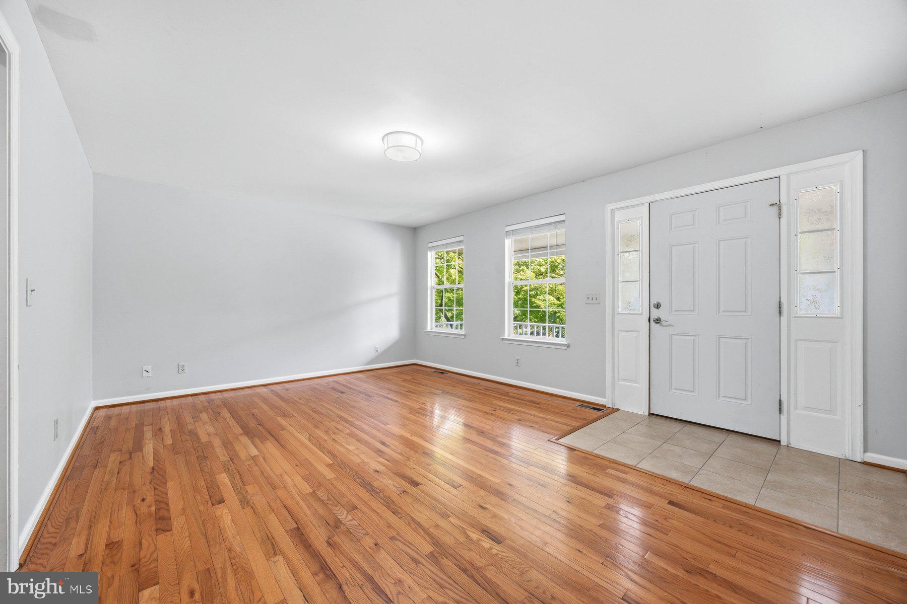 50 Robinson Landing Road Severna Park, MD 21146 - Photo 9 of 38 an empty room with wooden floor and windows