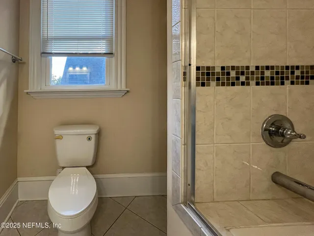 a bathroom with a toilet and a shower