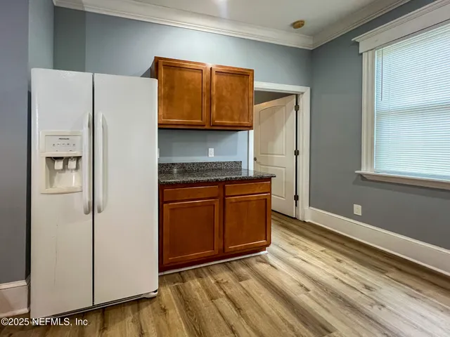 a kitchen with stainless steel appliances a refrigerator and a stove top oven