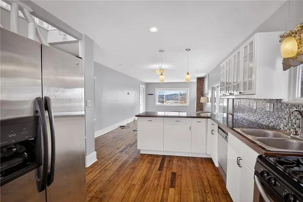 a kitchen with a sink stove and refrigerator